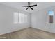 Bright bedroom featuring wood flooring, natural light, a ceiling fan and white walls at 16013 S Desert Foothills Pkwy # 1133, Phoenix, AZ 85048