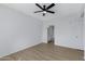 Minimalist bedroom with wood flooring, a ceiling fan and an adjacent bathroom entrance at 16013 S Desert Foothills Pkwy # 1133, Phoenix, AZ 85048