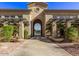 Arched entrance to the community with manicured landscaping and inviting walkway at 16013 S Desert Foothills Pkwy # 1133, Phoenix, AZ 85048