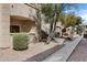 Exterior showcases stairs leading to second-story units, surrounded by gravel and trees at 16013 S Desert Foothills Pkwy # 1133, Phoenix, AZ 85048
