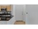 Stylish kitchen featuring black countertops and stainless steel appliances, leading to a white entrance door at 16013 S Desert Foothills Pkwy # 1133, Phoenix, AZ 85048