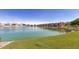 Scenic view of a lake surrounded by community buildings and lush green landscaping at 16013 S Desert Foothills Pkwy # 1133, Phoenix, AZ 85048
