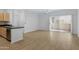 Open concept living room featuring wood floors and sliding glass doors for ample natural light at 16013 S Desert Foothills Pkwy # 1133, Phoenix, AZ 85048