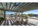 Stone picnic table under a pergola overlooking a lake at 16013 S Desert Foothills Pkwy # 1133, Phoenix, AZ 85048