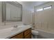Traditional bathroom with a tub and shower combination, vanity and framed mirror at 1615 W Hidalgo Ave, Phoenix, AZ 85041