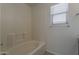 Bright bathroom with white tiled shower and window offers a clean and functional space at 1615 W Hidalgo Ave, Phoenix, AZ 85041