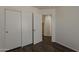 A bedroom features hardwood floors and a closet for storage at 1615 W Hidalgo Ave, Phoenix, AZ 85041