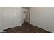 A bedroom features hardwood floors and a closet for storage at 1615 W Hidalgo Ave, Phoenix, AZ 85041