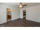 Bedroom with en-suite bathroom and access to the kitchen, featuring wood-look floors and neutral paint at 1615 W Hidalgo Ave, Phoenix, AZ 85041