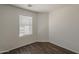 This bedroom offers a window for natural light, neutral walls, and hardwood floors at 1615 W Hidalgo Ave, Phoenix, AZ 85041