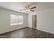 Bedroom with ceiling fan, natural light and wood-look floors creates a relaxing space with easy access to the bathroom at 1615 W Hidalgo Ave, Phoenix, AZ 85041