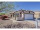 Charming single-story home with a desert landscape and a two car garage under a bright blue sky at 1615 W Hidalgo Ave, Phoenix, AZ 85041