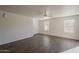 Well-lit living room featuring wood floors, ceiling fan, and dual pane windows for natural light at 1615 W Hidalgo Ave, Phoenix, AZ 85041