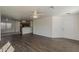 Inviting open-concept living room with wood floors, a ceiling fan, and an adjoining kitchen area at 1615 W Hidalgo Ave, Phoenix, AZ 85041