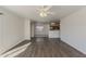 Open living space showcasing wood floors, ceiling fan, and a view into the adjacent kitchen area at 1615 W Hidalgo Ave, Phoenix, AZ 85041