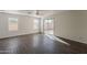 Sunny living room with wood floors, a ceiling fan, and sliding glass doors that lead to the backyard patio at 1615 W Hidalgo Ave, Phoenix, AZ 85041