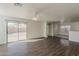 Bright and spacious living room featuring wood floors, ceiling fan, and sliding glass doors to the outdoor patio at 1615 W Hidalgo Ave, Phoenix, AZ 85041
