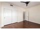 Bedroom featuring hardwood floors, ceiling fan, and double door closet at 16608 N 51St St, Scottsdale, AZ 85254