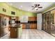 Well-lit kitchen features stainless steel appliances, island, and tile flooring with a sliding door at 16608 N 51St St, Scottsdale, AZ 85254