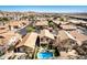 Aerial view of a home featuring a sparkling backyard pool, outdoor kitchen, seating area, and fenced-in yard at 16834 S 20Th Pl, Phoenix, AZ 85048