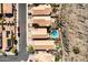 Aerial view of neighborhood homes with tile roofs, and one features a backyard pool and desert landscaping at 16834 S 20Th Pl, Phoenix, AZ 85048