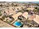 Aerial view of a home featuring a sparkling backyard pool, outdoor kitchen, seating area, and fenced-in yard at 16834 S 20Th Pl, Phoenix, AZ 85048