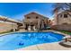 Spacious backyard with a sparkling pool, outdoor seating, lush green grass, and a playful play set at 16834 S 20Th Pl, Phoenix, AZ 85048
