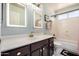 Bright bathroom featuring a vanity with lit mirrors, modern fixtures, and tub with shower at 16834 S 20Th Pl, Phoenix, AZ 85048
