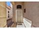 Covered entryway with a decorative security door, bench seating, and exterior wall decor at 16834 S 20Th Pl, Phoenix, AZ 85048