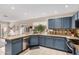 Well-equipped kitchen featuring blue cabinets, granite countertops, and stainless steel appliances at 16834 S 20Th Pl, Phoenix, AZ 85048