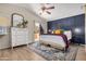 Elegant main bedroom featuring modern accent wall and private outdoor access at 16834 S 20Th Pl, Phoenix, AZ 85048