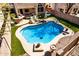 Inviting backyard pool with pristine landscaping, lounge chairs, an outdoor kitchen, and a playground at 16834 S 20Th Pl, Phoenix, AZ 85048