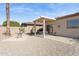 Private backyard featuring a covered patio, desert landscaping, and gravel groundcover at 16913 W Cortaro Point Dr, Surprise, AZ 85387