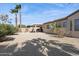 Desert backyard with patio, cacti, gravel groundcover, and lush, mature landscaping at 16913 W Cortaro Point Dr, Surprise, AZ 85387