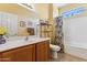 Bright bathroom featuring a white sink and a shower and bathtub combination at 16913 W Cortaro Point Dr, Surprise, AZ 85387