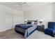 Cozy bedroom featuring neutral carpet, ceiling fan, and a comfortable bed setup at 16913 W Cortaro Point Dr, Surprise, AZ 85387