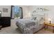Bedroom features a large window, carpet and decor shelves along the wall at 16913 W Cortaro Point Dr, Surprise, AZ 85387