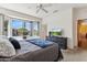 Comfortable bedroom features a bay window, TV on dresser, and view of the outdoor scenery at 16913 W Cortaro Point Dr, Surprise, AZ 85387