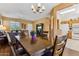 Open-concept dining area adjacent to a cozy living room and kitchen at 16913 W Cortaro Point Dr, Surprise, AZ 85387