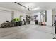 Spacious garage featuring ample storage space, utility sink, and modern water heater at 16913 W Cortaro Point Dr, Surprise, AZ 85387