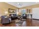 Cozy living room featuring hardwood floors, comfortable seating, and natural light at 16913 W Cortaro Point Dr, Surprise, AZ 85387