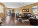 Spacious living room with wood floors, ample seating, and adjacent dining area at 16913 W Cortaro Point Dr, Surprise, AZ 85387