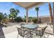 Relaxing covered patio with comfortable seating and a well-kept desert landscape at 16913 W Cortaro Point Dr, Surprise, AZ 85387