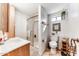 Functional bathroom featuring a shower, toilet, vanity, and storage with bright lighting at 17200 W Bell Rd # 2221, Surprise, AZ 85374