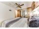 Comfortable bedroom featuring mirrored closet doors and a ceiling fan for added comfort at 17200 W Bell Rd # 2221, Surprise, AZ 85374