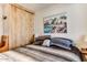 Comfortable bedroom featuring a landscape painting, wood-look flooring, a window, and a closet at 17200 W Bell Rd # 2221, Surprise, AZ 85374