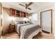 Cozy bedroom with wood-look flooring, ceiling fan, and built-in storage, creating a comfortable retreat at 17200 W Bell Rd # 2221, Surprise, AZ 85374