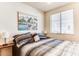 Bright bedroom featuring a large window, artwork, and a comfortable bed, creating a serene and inviting space at 17200 W Bell Rd # 2221, Surprise, AZ 85374