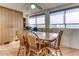 Traditional dining room featuring a wood table and chairs, a ceiling fan, and natural light from large windows at 17200 W Bell Rd # 2221, Surprise, AZ 85374