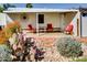 Covered porch features seating, stone landscaping, and desert vegetation at 17200 W Bell Rd # 2221, Surprise, AZ 85374